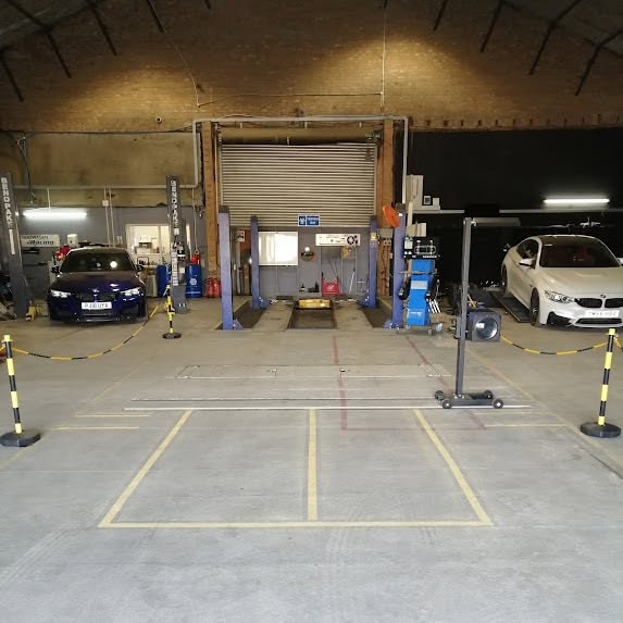 Inside the TJ Vehicle Services workshop, with vehicles in the service bays